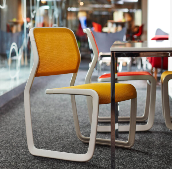 Newson Aluminum Stacking Chairs with orange seat and cream base
