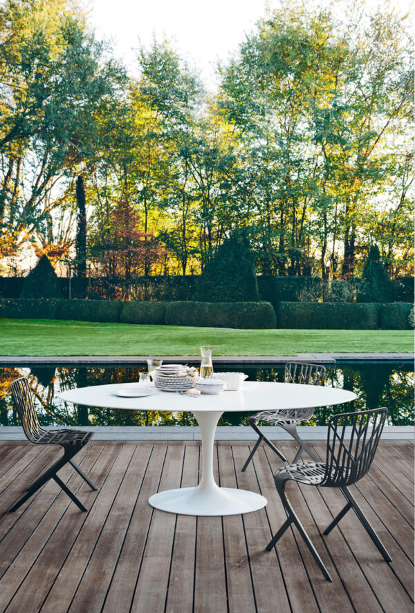 Washington Skeleton Side Chair outdoors with a white marble top table next to a pool
