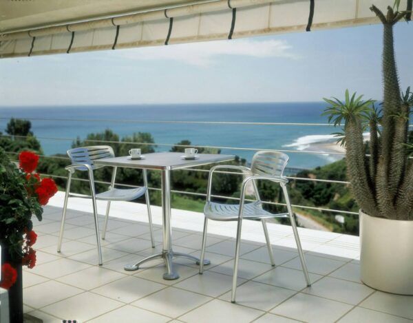 toledo aluminium stacking chair in a terrace with ocean view
