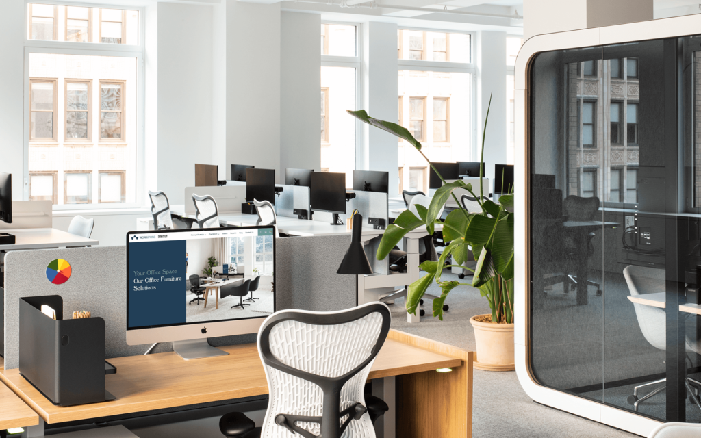 recently relocated office featurinf a soundproof booth and a desk with an ergonomic chair