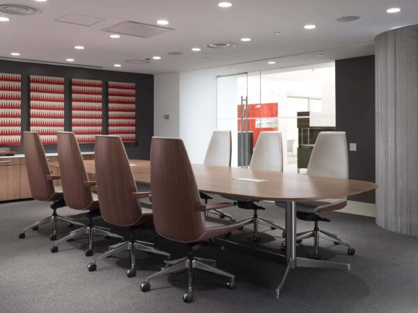 seven high back Clamshell Office Chairs at a modern meeting room around a wooden top meeting table