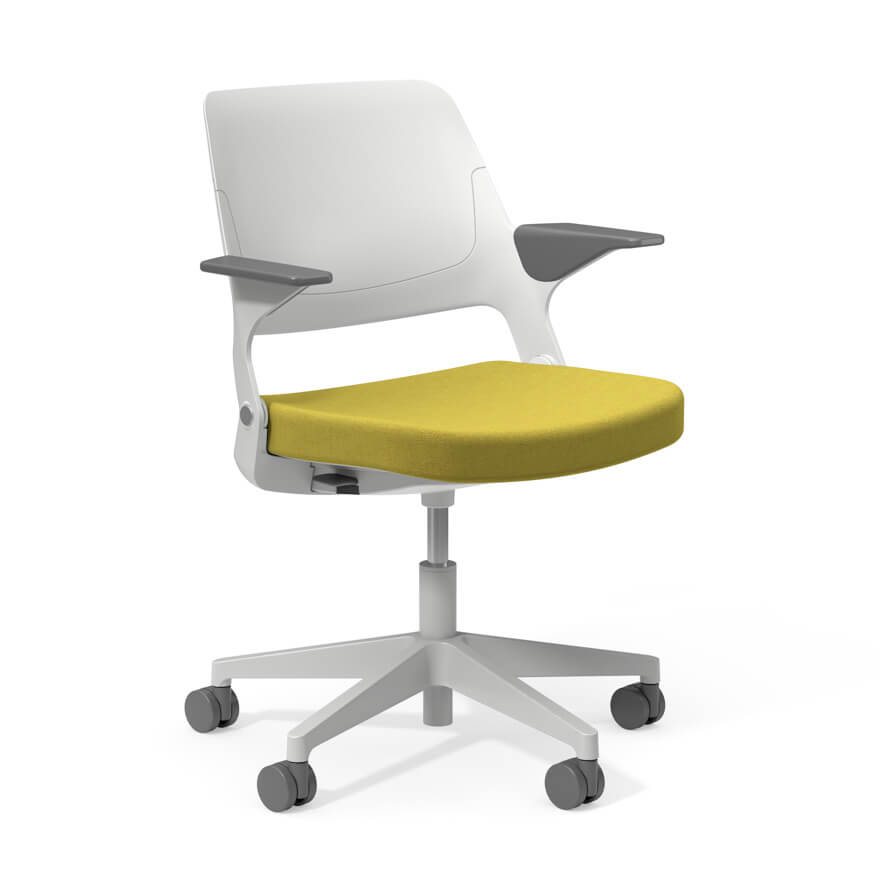 the side angle of an Ollo Side Chair with white back and light green seat with armrests