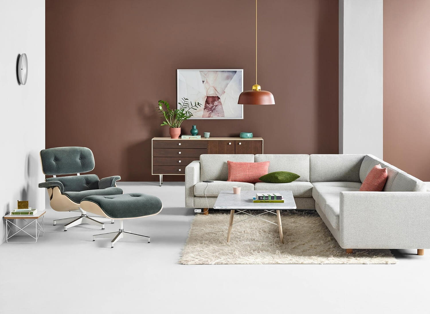 an elegand livingroom featuring a sofa and an eames lounge chair