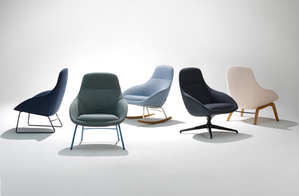 a set of five always lounge chairs in different colours and base styles in a white room